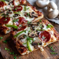 The Works flatbread pizza with pepperoni, vegetables, and mozzarella from Mother of Macros Cafe