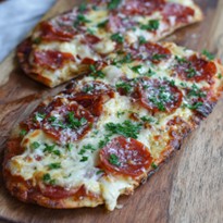 Pepperoni flatbread pizza with mozzarella and marinara from Mother of Macros Cafe